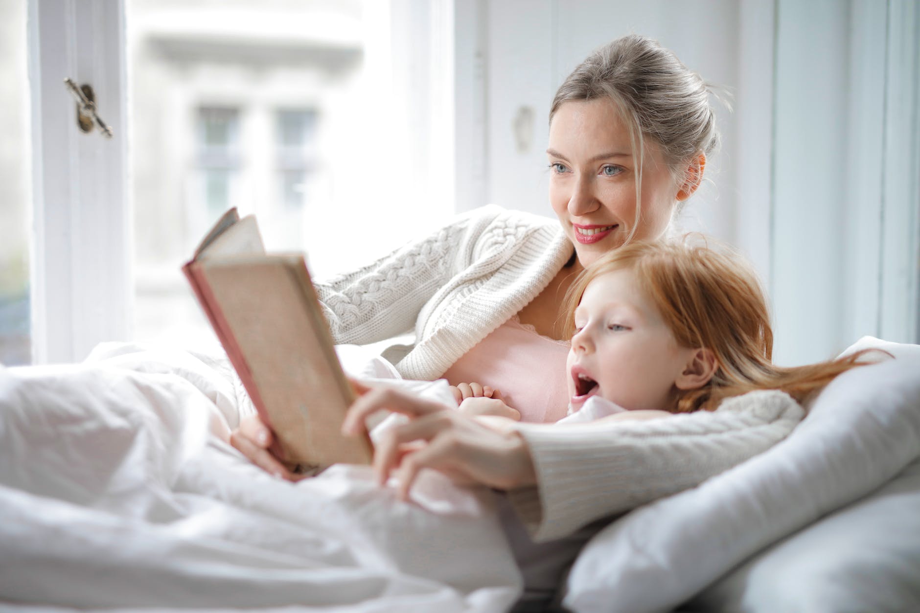 mother and daughter reading book with interest in bed
Nursery Bookshelf Set