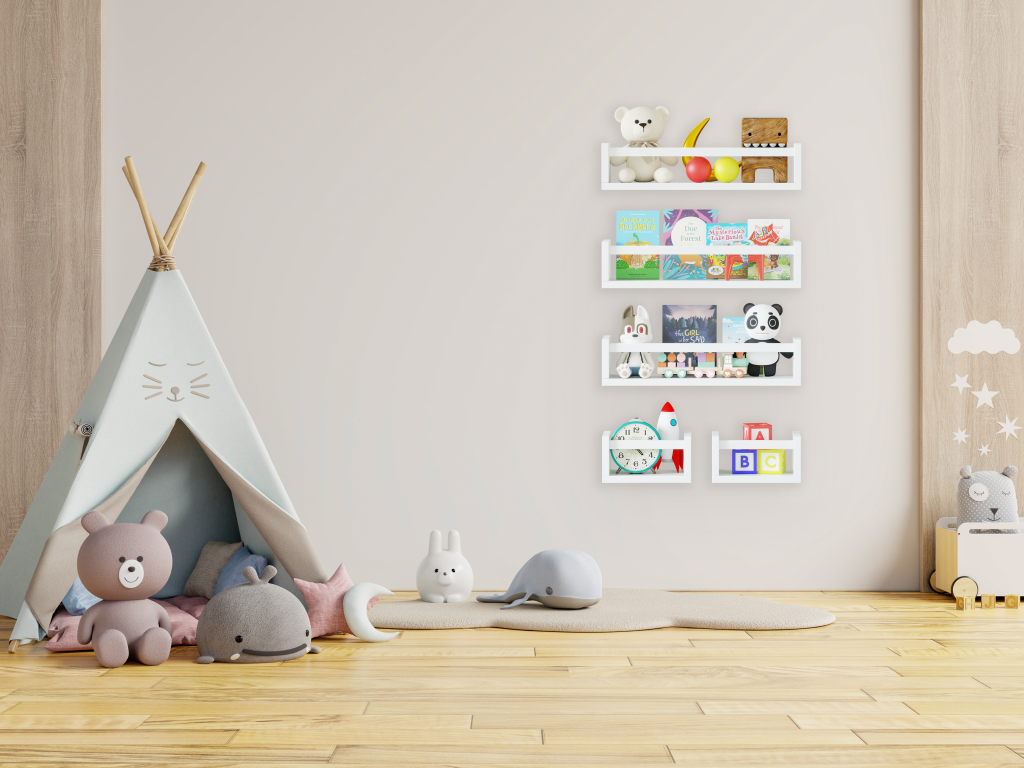 Children's playroom with a small teepee tent and stuffed animals on the floor, wall-mounted nursery bookshelves filled with books and toys, and wooden flooring with minimalistic decor.