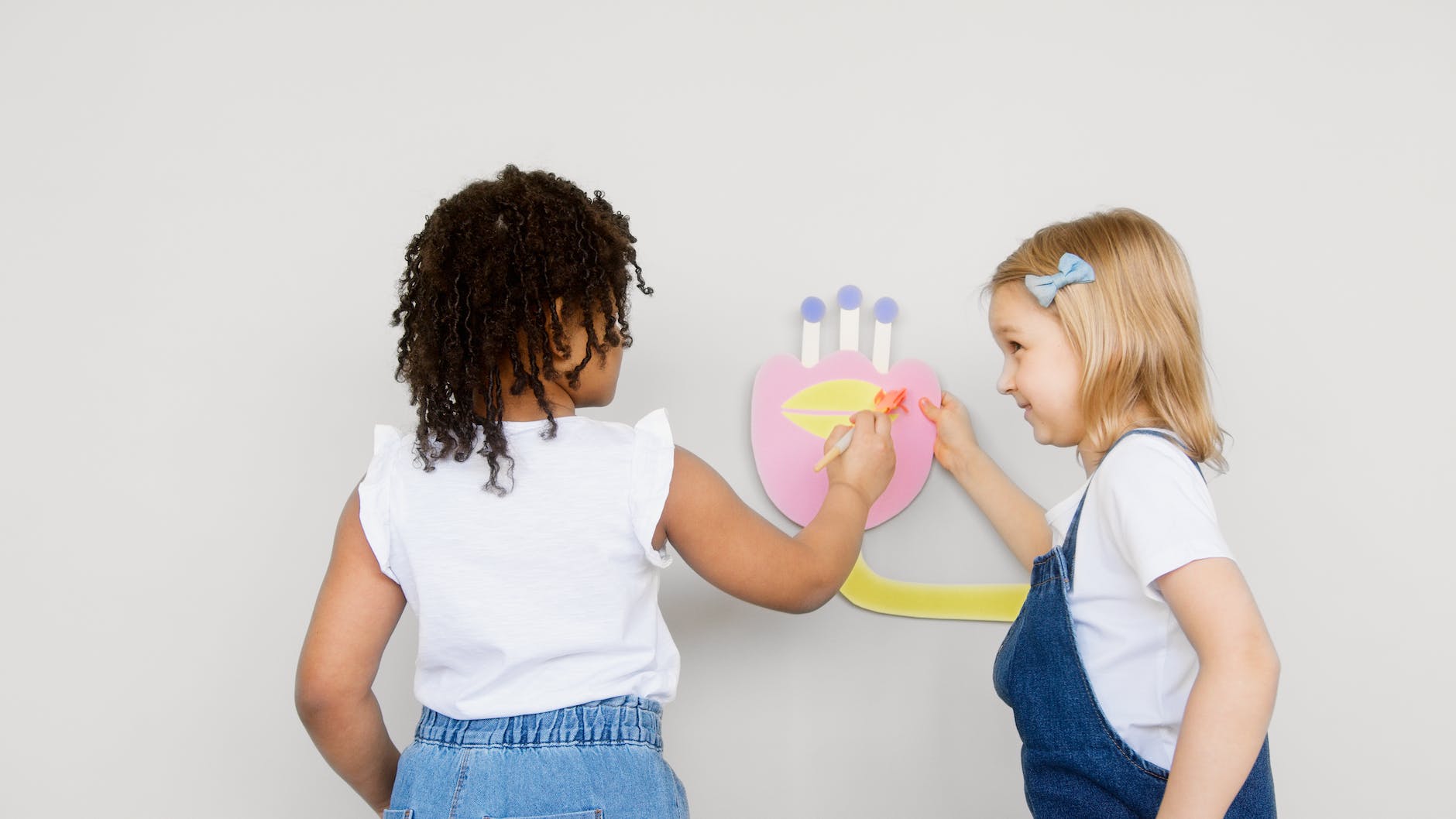 two kids doing some artwork