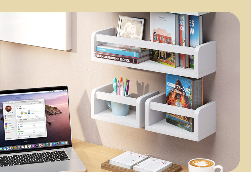 nursery book shelf mounted above a laptop in an office setting