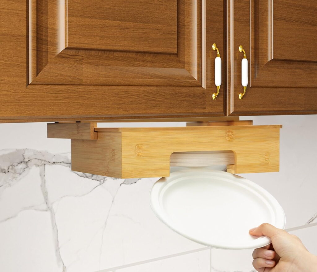 a hand pulling a paper plate from a wooden paper plate dispenser.