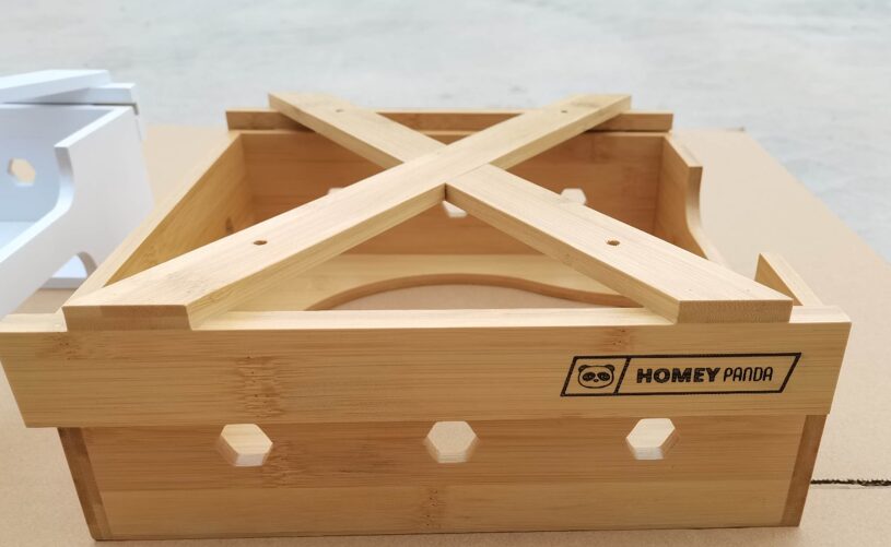 Close-up view of the bamboo paper plate dispenser frame with Homey Panda logo
