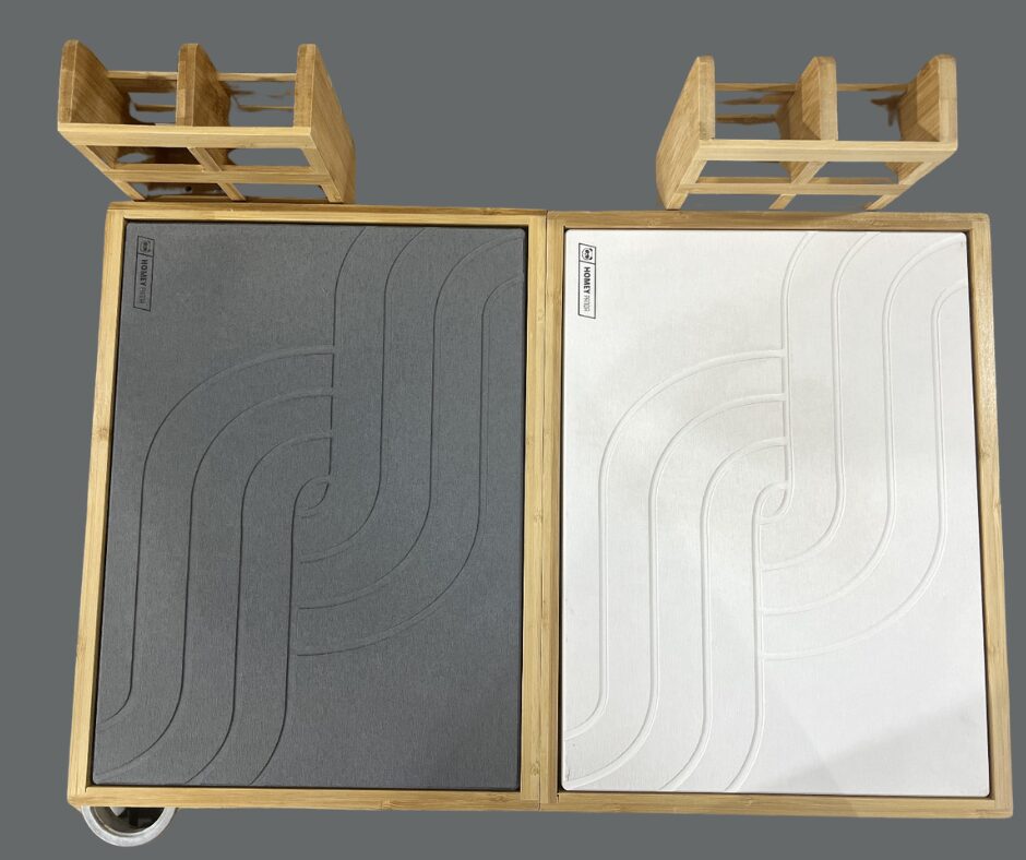 Top view of a double stone drying mat setup, featuring a gray and a white mat with matching curved line patterns. The mats are held within a bamboo frame and include wooden holders for organizing kitchen items.