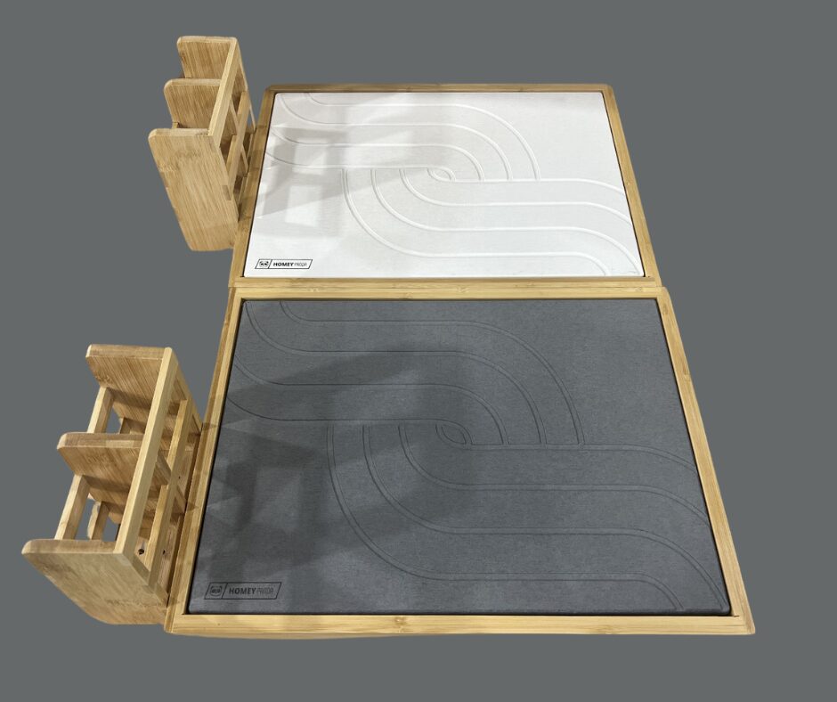 Top view of two stone drying mats, one in white and one in gray, both featuring curved line patterns. The mats are framed in bamboo wood and include a side holder for utensils or small items. The design combines functionality and modern aesthetics.