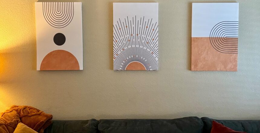 Three boho artwork for wall displayed above a sofa, showcasing geometric designs in earthy tones that match the living room decor. A perfect arrangement of boho canvas wall art to create a warm and inviting atmosphere.