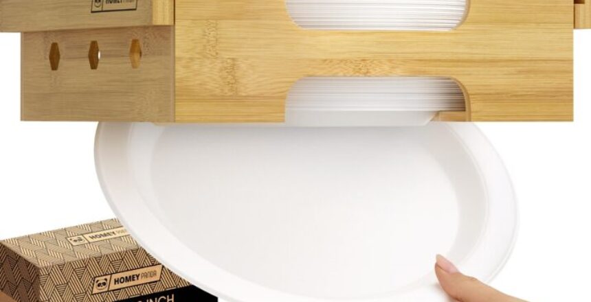 A bamboo paper plate dispenser mounted under a cabinet, with a hand pulling out a white paper plate.